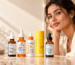Woman beside five vitamin C face serums from The Ordinary, La Roche-Posay, Paula’s Choice, Timeless and SkinCeuticals