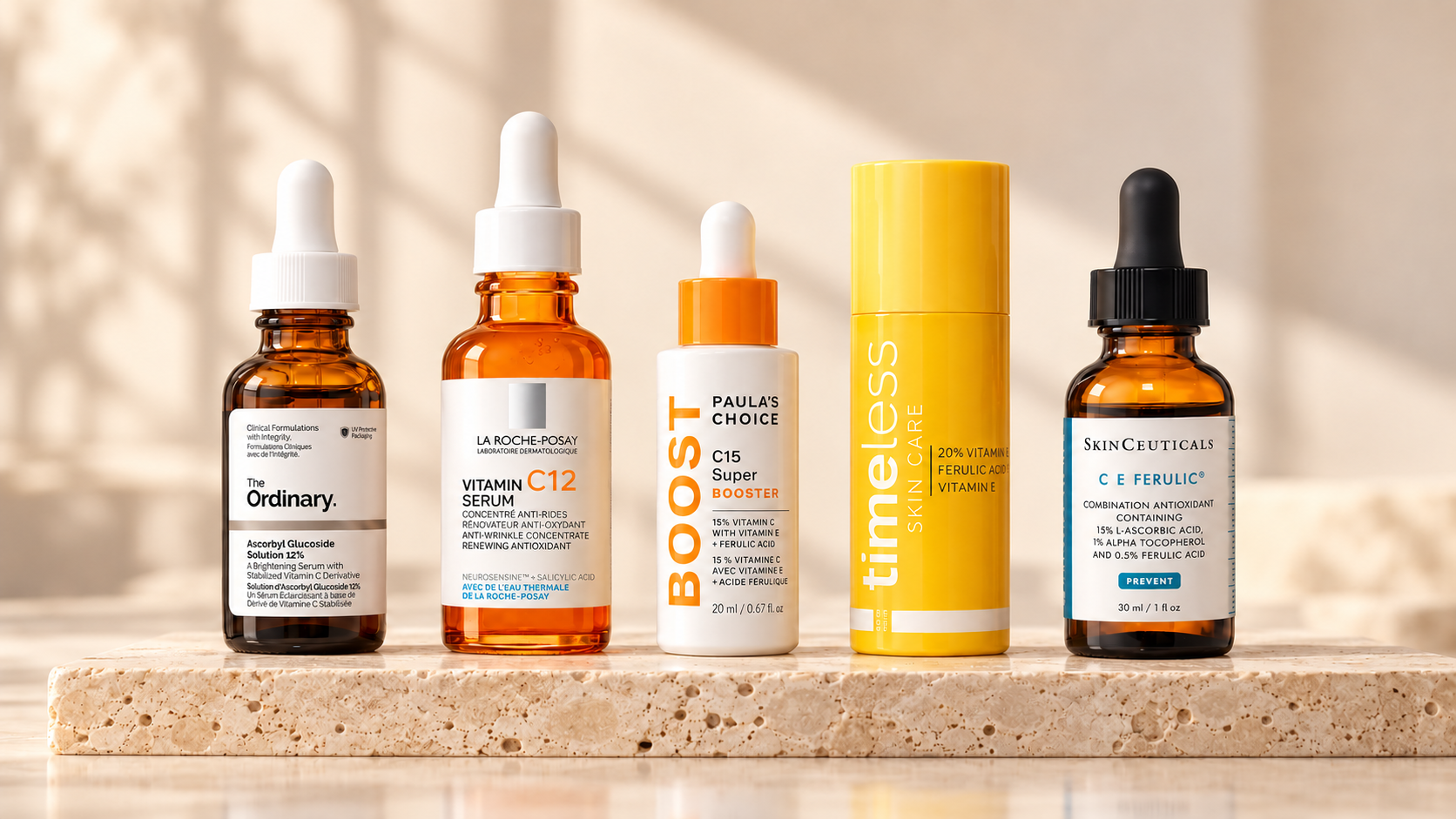Five vitamin C serums including La Roche-Posay Vitamin C12 displayed on a stone stand